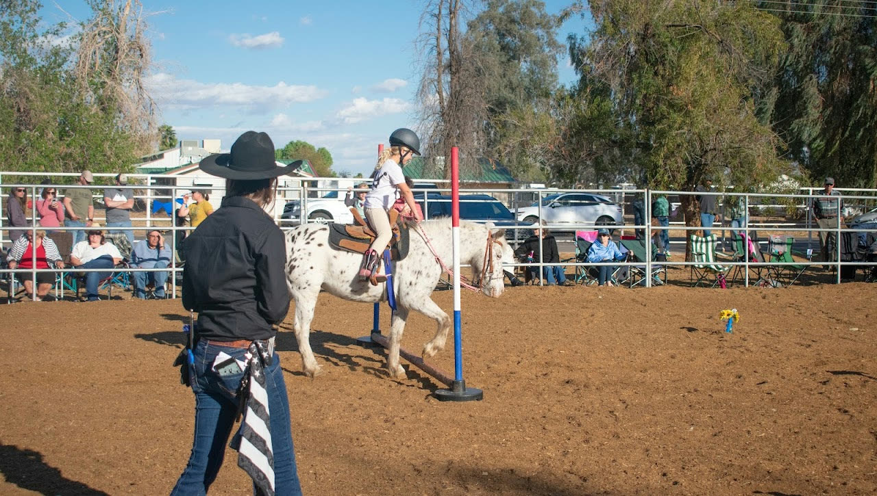 An instructor guiding a rider in the arena